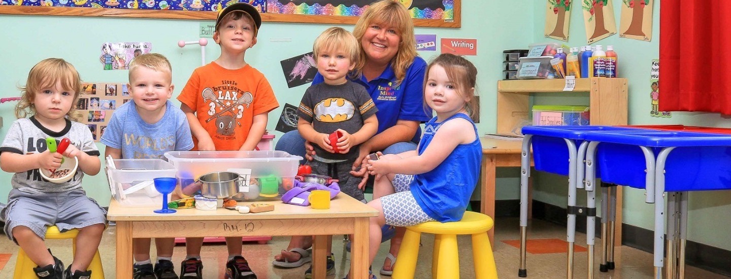 Miss Jessica and students playing together in the classroom